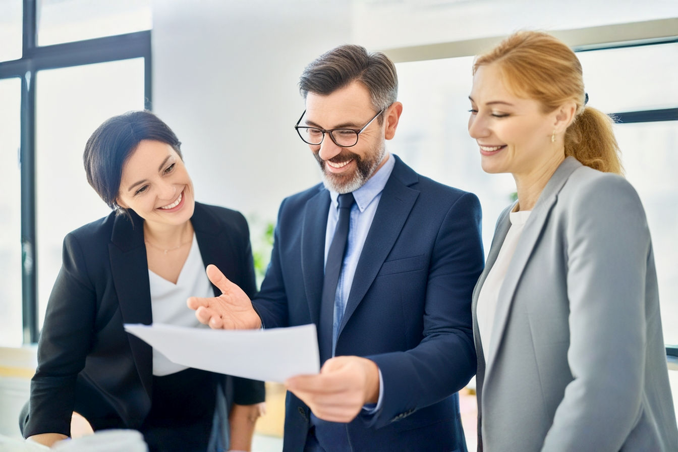 Professional, lifelike photograph. A group of three business professionals (e.g., one man, two women, varied ethnicities) are collaboratively reviewing a document or tablet in a modern, bright office setting. One person, clearly a PR strategist, is confidently explaining a point, gesturing towards the document. The atmosphere is positive, engaged, and strategic. Focus on clear, optimistic facial expressions. Soft, natural lighting. Depth of field with a slightly blurred background of a contemporary office.