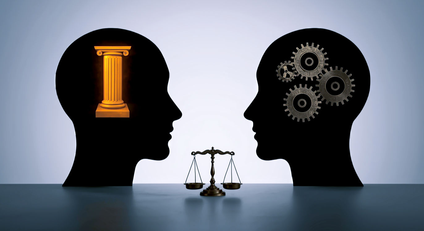 Professional DSLR photo, 16:9, soft studio lighting. Subject: Two stylized, abstract human head silhouettes, facing each other. One head has a glowing, solid "pillar" or "pedestal" inside, representing esteem. The other head has a series of interlocking "gears" or "levers" visible, representing abilities and confidence. Foreground: A subtle visual element symbolizing measurement or comparison, like a small, antique balance scale, slightly out of focus. Background: A clean, minimalist grey or off-white background. Mood: Illuminating. Note: NO text, NO abstract graphics. The image should subtly differentiate the concepts without explicitly labeling them.